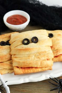 some food is on a white plate with black eyes and googly eyes in the middle