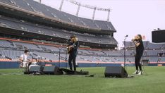 two women on stage in front of an empty stadium