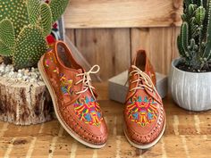 Let your shoes be the star of the show when you wear these beautiful Artisanal Mexican Shoes! These premium quality shoes are made from Mexican leather, feature beautiful multicolor traditional embroidered design and has laces for an adjustable fit. These are the highest quality in Artisanal leather shoes. They are completely made by hand, making them one of a kind! How to order your size: Example, If you wear a size 7.5 order a 7. If you are a size 7 order a 7. The sandal will mold to your feet Casual Embroidered Huarache Sandals For Festival, Embroidered Leather Huarache Sandals For Festival, Leather Embroidered Huarache Sandals For Festivals, Traditional Hand Tooled Huaraches With Round Toe, Traditional Hand Tooled Huaraches For Spring, Traditional Handmade Multicolor Huaraches, Traditional Multicolor Slip-on Huaraches, Traditional Leather Lace-up Shoes With Rubber Sole, Traditional Leather Lace-up Shoes With Leather Sole