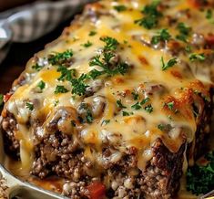 a casserole dish with meat, cheese and vegetables