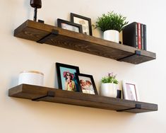 two wooden shelves with pictures and photos on them