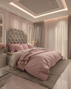 a bedroom with a large bed covered in pink comforter and pillows on top of it