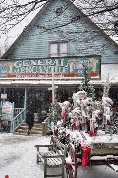 a bench covered in snow sitting next to a building with a sign that says general meronie