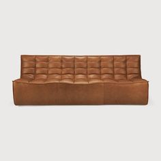 a brown leather couch on a white background