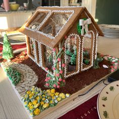 a gingerbread house made to look like it is in the middle of a table