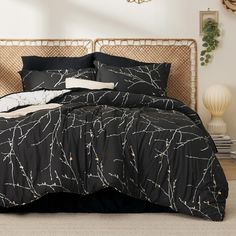 a bed with black comforter and pillows on it