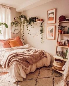 a bedroom with lots of plants and pictures on the wall above the bed, along with hanging planters