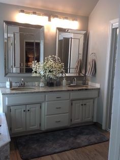 a bathroom with two sinks and mirrors in it