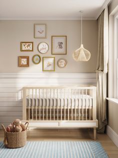 a baby's room with a crib and various framed pictures on the wall