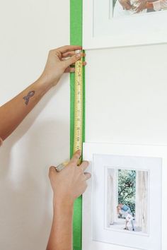 a person is measuring the wall with a tape