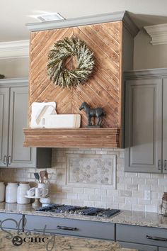 the kitchen is decorated for christmas with wreaths and other decorations on the wall above the stove