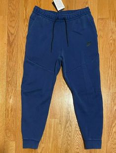 Blue Relaxed Fit Fleece Pants, Nike Blue Fleece Bottoms, Nike Fitted Sweatpants With Pockets, Nike Blue Relaxed Fit Sweatpants, Blue Fitted Sweatpants For Streetwear, Fitted Blue Sweatpants For Streetwear, Nike Tech Pants, Tech Pants, Nike Sportswear Tech Fleece