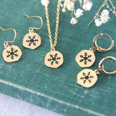 "A delightful collection of winter themed gold plated snowflake jewellery. Choose between a necklace, huggie hoop earrings or earwire earrings. The shiny snowflake charms are lightly textured and are perfect to add that wintery detail to any outfit.  The snowflake charms measure 1cm tall (0.4\"). If you are selecting the necklace option, please also select the chain length you would like from the drop down menu.  All materials are gold plated brass. Delivered to you gift boxed ready to give as a Christmas Jewelry Set As Gift With Matching Earrings, Christmas Jewelry Gift With Matching Earrings, Christmas Jewelry Gift Set With Matching Earrings, Sterling Silver Jewelry For Winter Gifts, Snowflake Jewelry For Holiday Gifts, Holiday Dangle Jewelry Gift, Holiday Dangle Jewelry For Gifts, Handmade Gold Jewelry For Holidays, Holiday Gift Dangle Jewelry