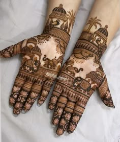 two hands with henna designs on them