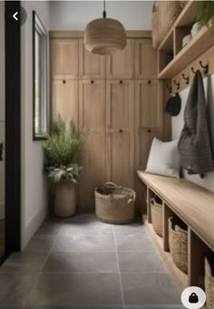 a hallway with wooden shelves and baskets on the floor