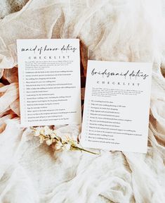 two wedding checklists sitting on top of a bed next to a bouquet of flowers