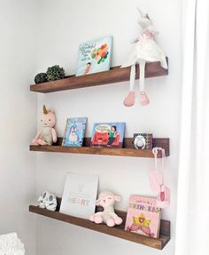 three wooden shelves with books and toys on them