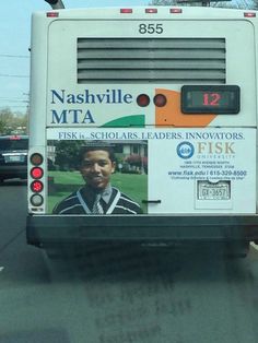 a bus driving down the road with an advertisement on it's side