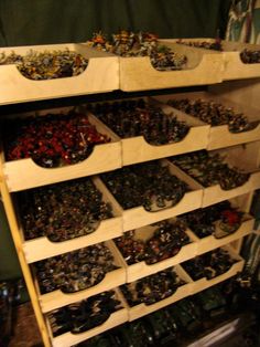 a wooden shelf filled with lots of toy figurines