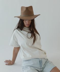 The June Teardrop Rancher is a felt Western hat with a modern twist. The June is a hat with a teardrop-shaped crown and angled Western brim. Bound with a tonal grosgrain ribbon around the brim edge, this teardrop hat encapsulates elevated Western style. Hat Trends, Tall Crown, Gigi Pip, Classy Hats, Modern Cowgirl, Western Hat, Halo Style, Rugged Style, Wearing A Hat