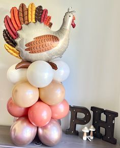 a large turkey balloon sitting on top of balloons