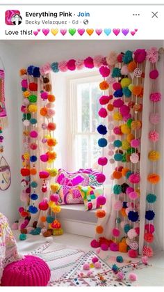 a bedroom decorated in bright colors with pom poms hanging from the ceiling and curtains