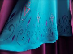 an image of a dress with blue and pink designs on it's back side