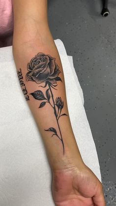 a person with a rose tattoo on their arm