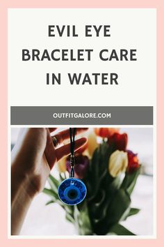 Hand holding an evil eye bracelet in front of a bouquet of tulips with text "Evil Eye Bracelet Care in Water". Shower Care, Cultural Beliefs, Spiritual Meaning, Eye Bracelet, Evil Eye Bracelet, Negative Energy, Evil Eye, Things To Come, Shower