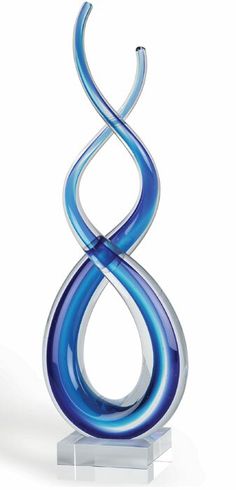 a blue glass sculpture is shown on a white base and stands in front of a white background