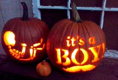 two pumpkins carved to look like they have faces carved into the words it's a boy