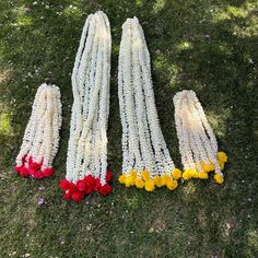 flowers laid out on the grass to be used as garlands