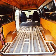 the back end of an old van with wood flooring in it's cargo area