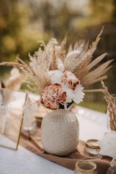 a vase filled with flowers sitting on top of a table