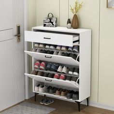 a white shoe rack with several pairs of shoes