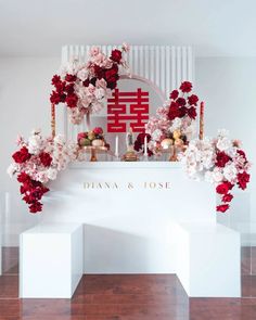 a white table topped with flowers and candles