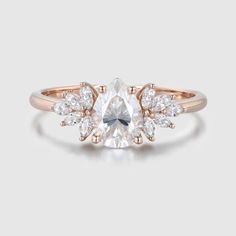 a rose cut diamond ring with three pear shaped diamonds