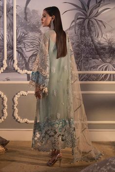 Heavily Embellished Pakistani Party Wear Salwar Kameez is as unique as the beautiful woman for whom it’s crafted, this exquisite look embellished with 3D flowers and pearls on a light teal canvas is bound to make a statement at every event. This aesthetic is enhanced further with beige French lace detailing and an embroidered border on a sea green silk fabric. A divinely ornamented stone beige net dupatta, woven jacquard pants, and a plain matching slip complete this whole look. Detailed Descrip Green Silk Fabric, Party Wear Salwar Kameez, Jacquard Pants, Party Wear Salwar, Pakistani Party Wear Dresses, Flowers And Pearls, Pakistani Party Wear, Sana Safinaz, Embroidered Border