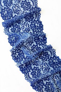 several pieces of blue lace on a white surface