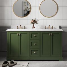 a bathroom with two sinks and mirrors on the wall next to each other in green cabinetry