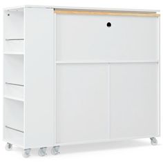 a white cabinet with three drawers and two shelves on wheels, against a white background