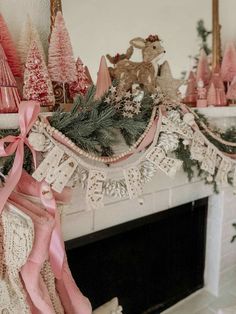 a fireplace decorated for christmas with pink and white decorations