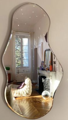 a mirror reflecting a living room with a fireplace