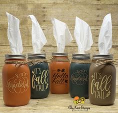 four painted mason jars with tissue paper in them, all labeled it's fall y'all