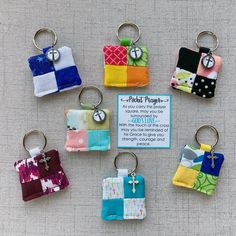 six keychains with different designs on them and a price tag for each one