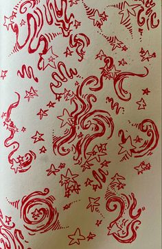 an image of red ink on white paper with stars and swirls in the background