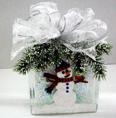 a snowman ornament in a clear glass jar