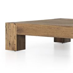 a wooden table sitting on top of a white floor