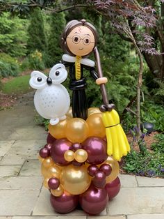 an inflatable statue of a woman and two owls on top of balloons