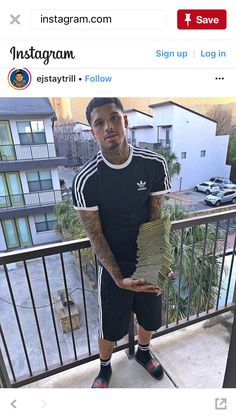 a man holding stacks of papers on top of a balcony with the caption instagram com